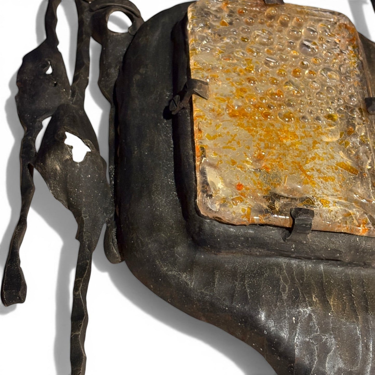 La Basilica Galeria Brutalist wall sconce with hand-welded dark metal frame and amber bubble glass.