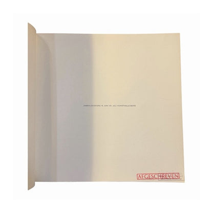Catálogo blanco de James Lee Byars abierto en página de título con sello rojo Afgeschreven