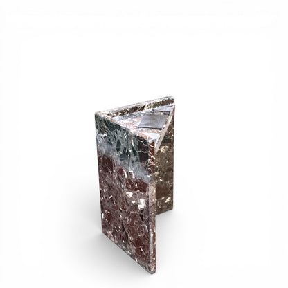 Detalle de pilar de soporte L-shaped de mesa de mármol y superficie con parche gris distintivo