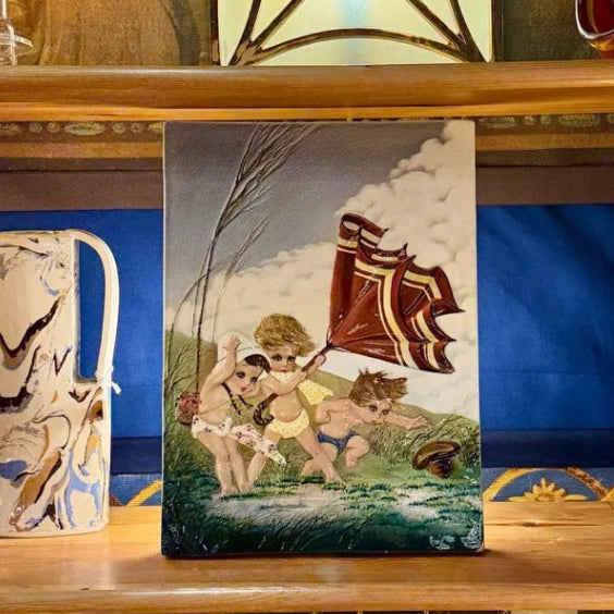 Antique enamelled ceramic plaque artwork by Mario Brunetti depicting a figurative scene of children with vibrant polychrome glazes and original framing.