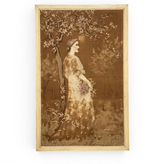 Pintura vintage de Marcel Rieder sobre tela que muestra a una mujer junto a un árbol en flor con marco de madera dorada acanalada