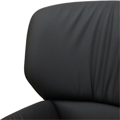 La Basilica Galeria Nuez Lounge Chair in black leather with a textured shell and oak swivel base. Sold without cushion.
