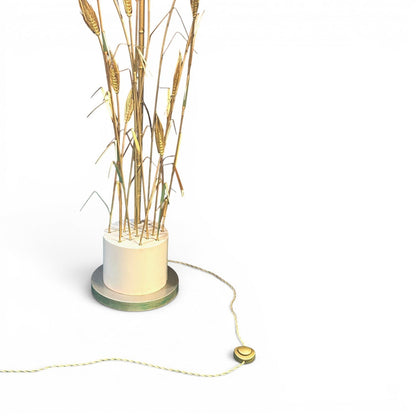 La Basilica Galeria brass wheat sheaf floor lamp with a cylindrical base and rear reflector disc, 1980s.