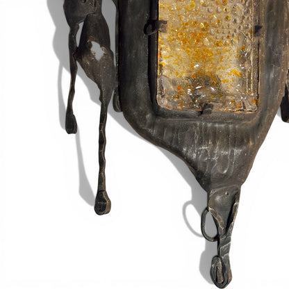La Basilica Galeria Brutalist amber glass and oxidized metal wall sconce with organic torch-cut silhouettes.