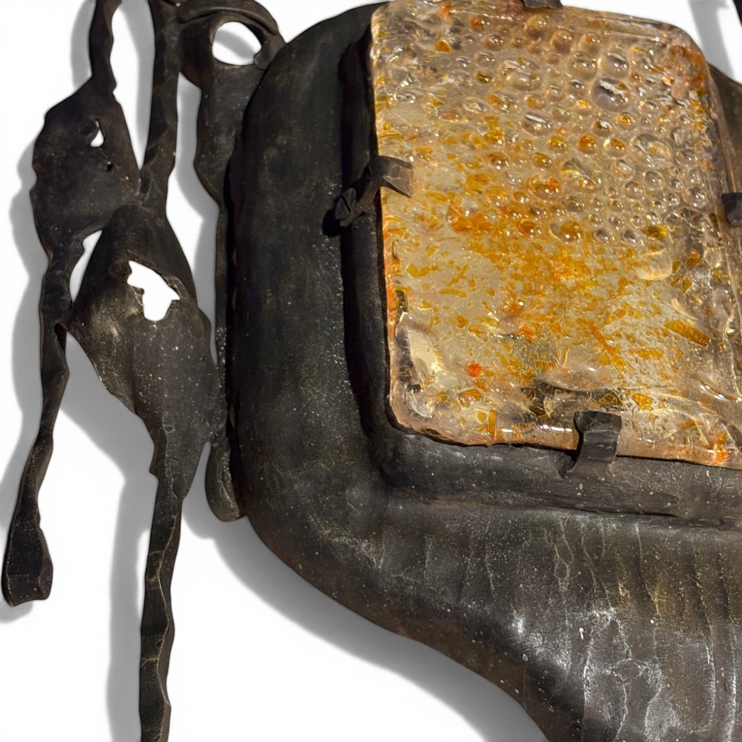 La Basilica Galeria Brutalist wall sconce with hand-welded dark metal frame and amber bubble glass.