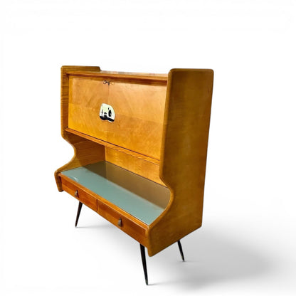 La Basilica Galeria Mid-Century Italian bureau sideboard in honey wood veneer with curved wings, smoke-grey glass top, and red lacquered interior.