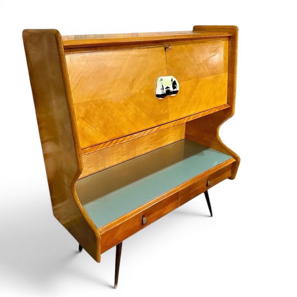La Basilica Galeria Mid-Century Italian bureau sideboard in honey-toned wood veneer with curved wings, smoke-grey glass top, and ceramic plaque.