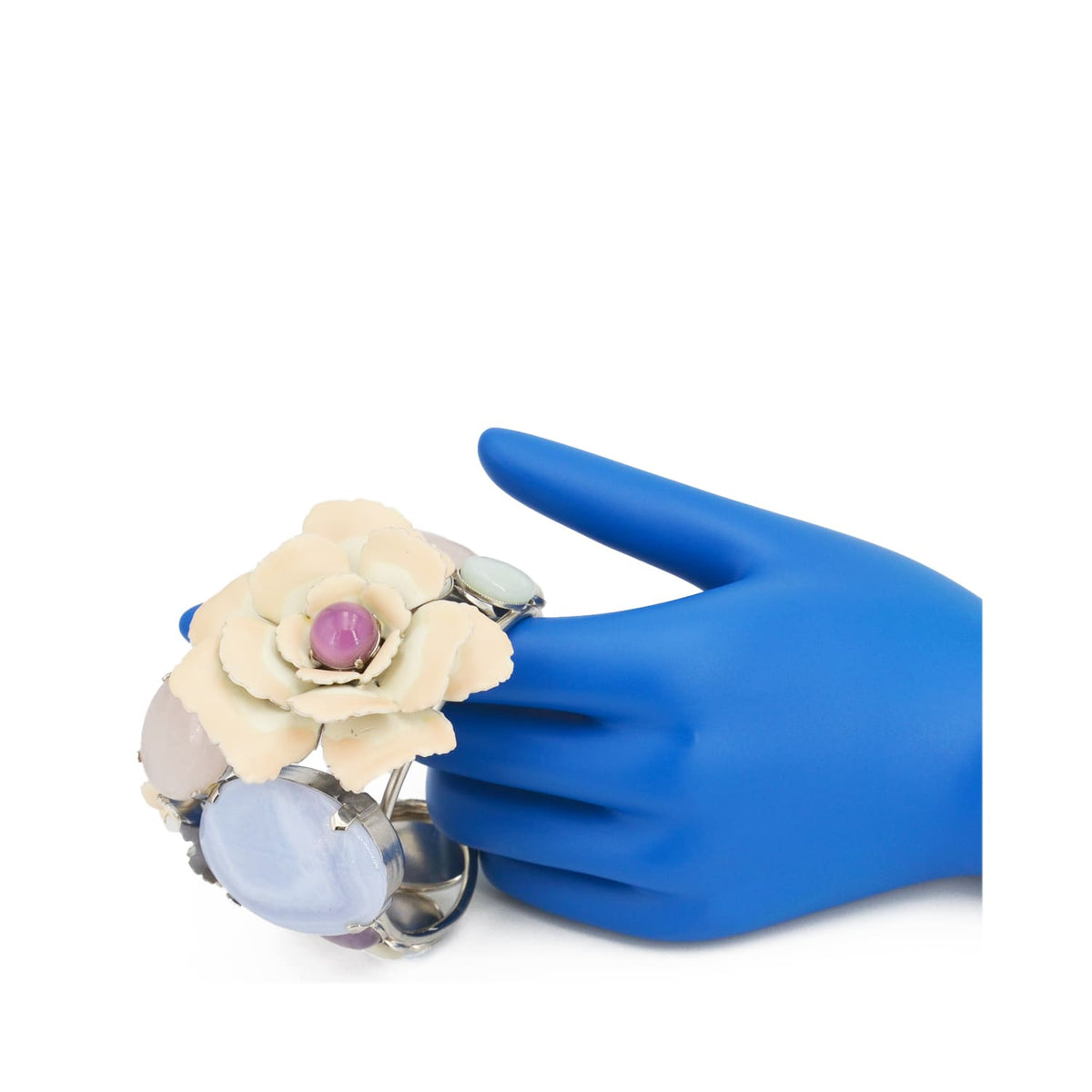 Statement bracelet on hand showing oversized enamel flower centerpiece