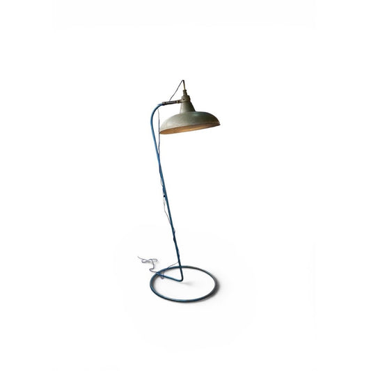 Lámpara de pie industrial vintage con cable azul enrollado en estructura metálica y base circular
